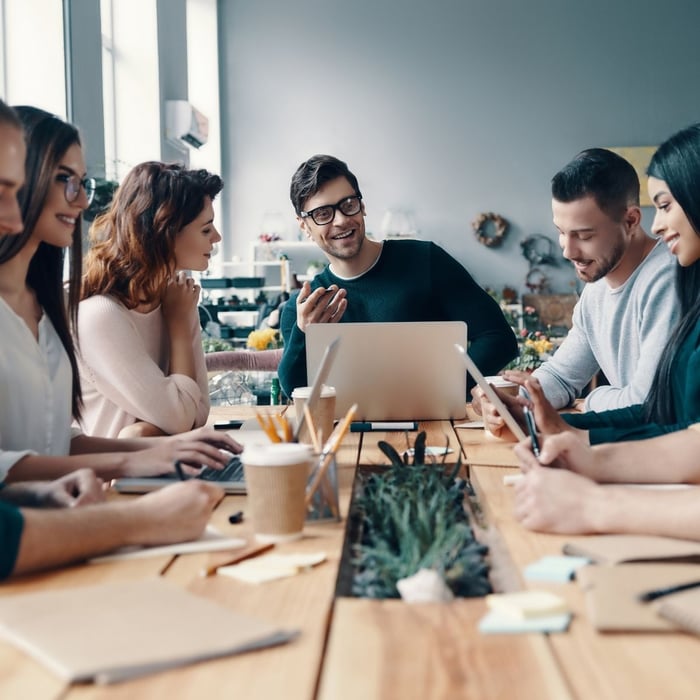 Team collaborating around a table in a bright office