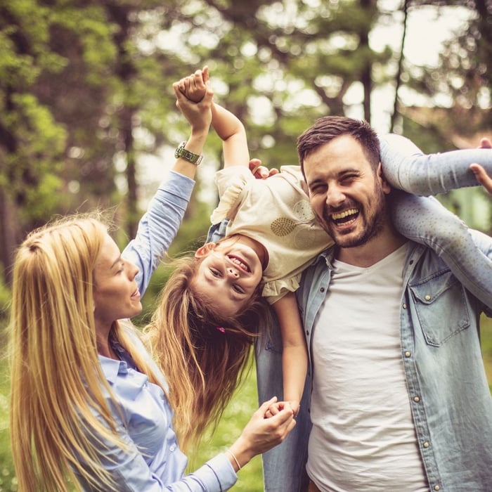 Happy family playing together outdoors