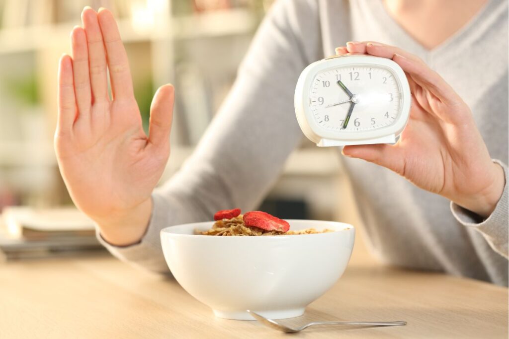 woman doing fasting holding a timer